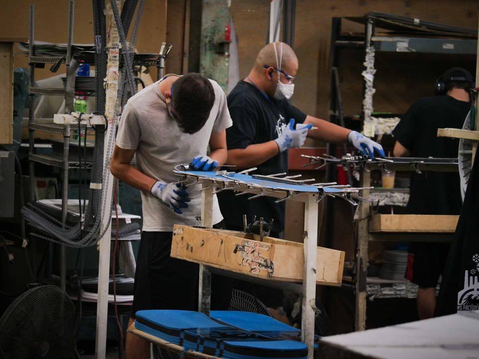 Workers at Never Summer Snowboards build hand made snowboard